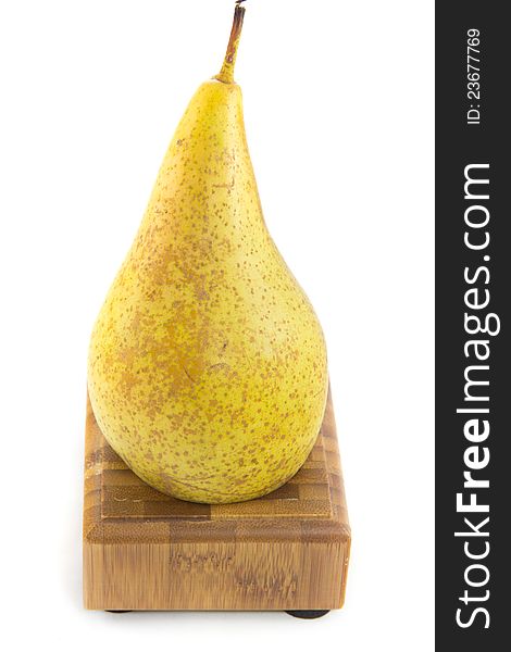 A picture of a pear sitting on a wooden stand. A picture of a pear sitting on a wooden stand