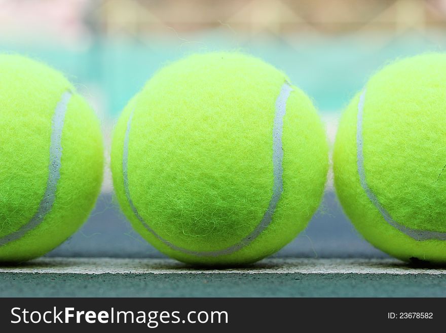 Photo of brand new tennis balls arranged in a row
