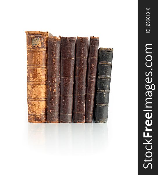 Few old books standing in a row on white background. Clipping path is included