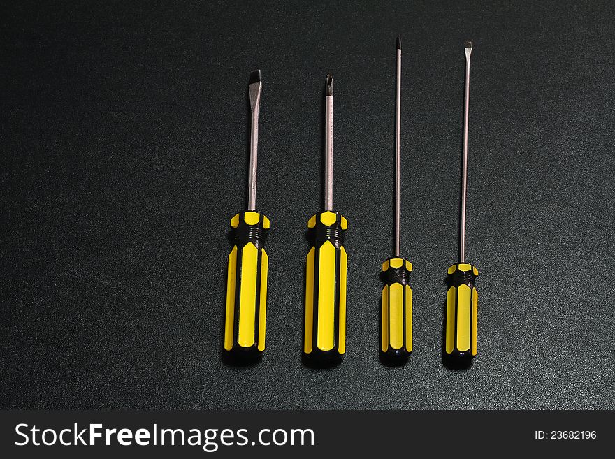 A bunch of used isolated screw drivers isolated on Black background.