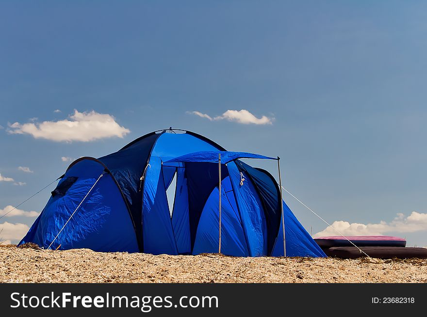 Blue tourist tent on the shore of the Black Sea in Crimea, Ukraine