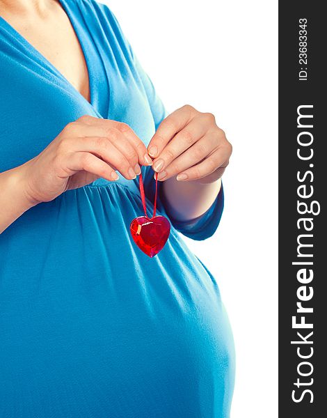 Pregnant woman holding heart over her tummy