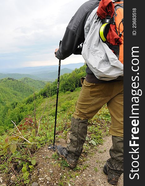 Hiker with backpack in the mountains