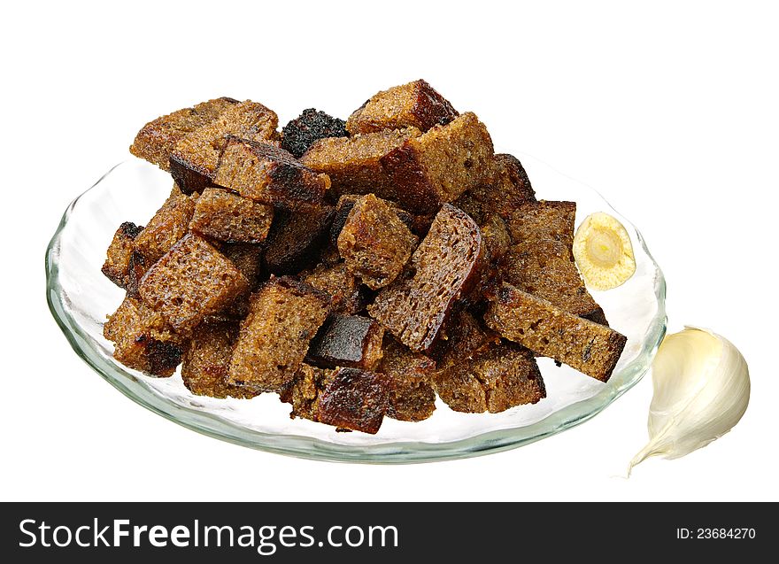Bread rusks with garlic on plate isolated on a white background