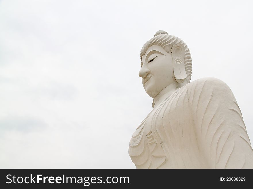 Closeup view of a historic buddha statue made of white marble