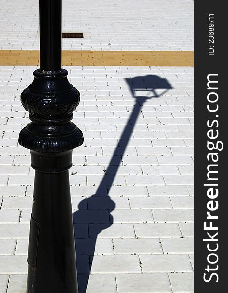 Detail of a street lamp with black shade. Detail of a street lamp with black shade