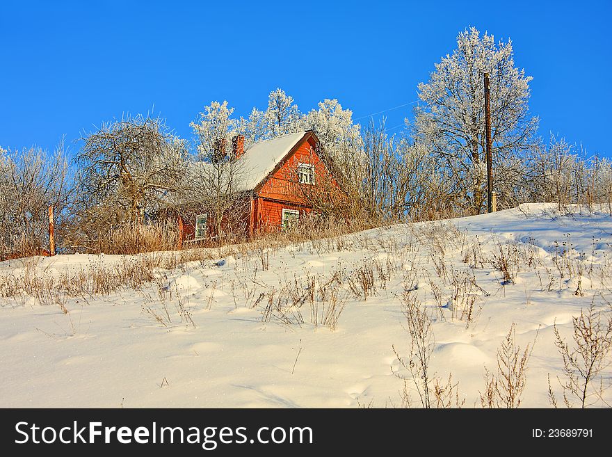 Winter landscape with a house on the hill