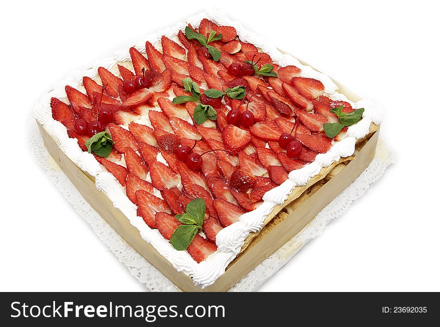 A large strawberry cake on white background
