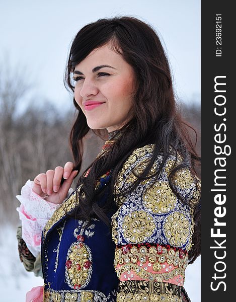 The portrait of a woman dressed in traditional Bulgarian costume.