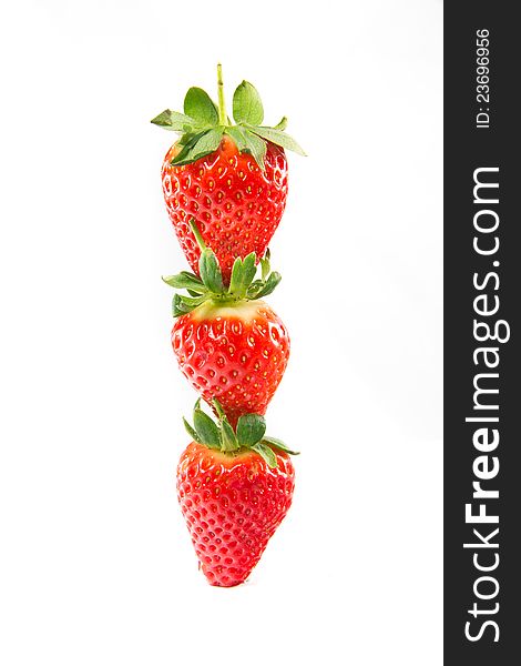 A picture of three strawberries stacked on top of eachother. A picture of three strawberries stacked on top of eachother