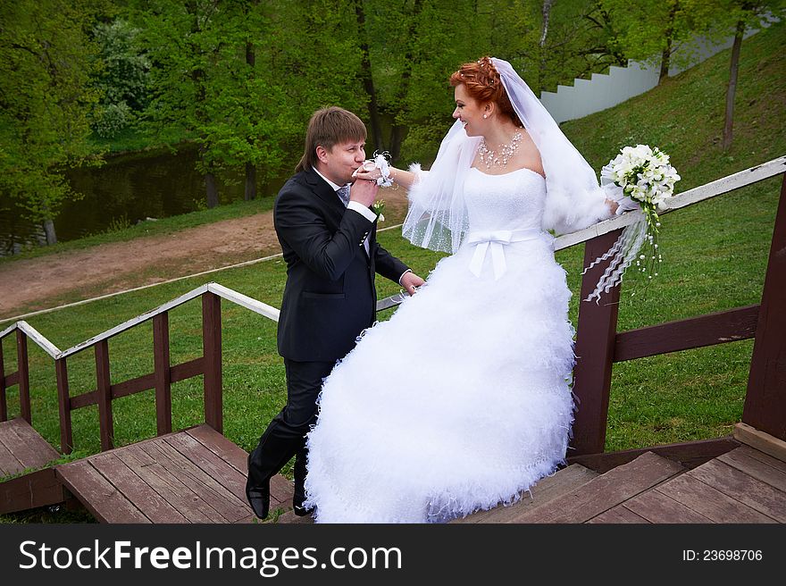 Bride and groom on stair in park