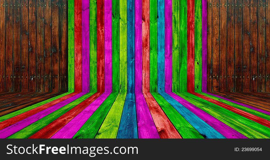 A creative wooden room with multicolored and brown planks as a background. A creative wooden room with multicolored and brown planks as a background