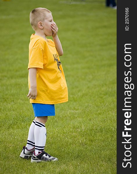 Here is a photo of a young boy playing soccer.  He is either bored or something astonishing just happened!. Here is a photo of a young boy playing soccer.  He is either bored or something astonishing just happened!