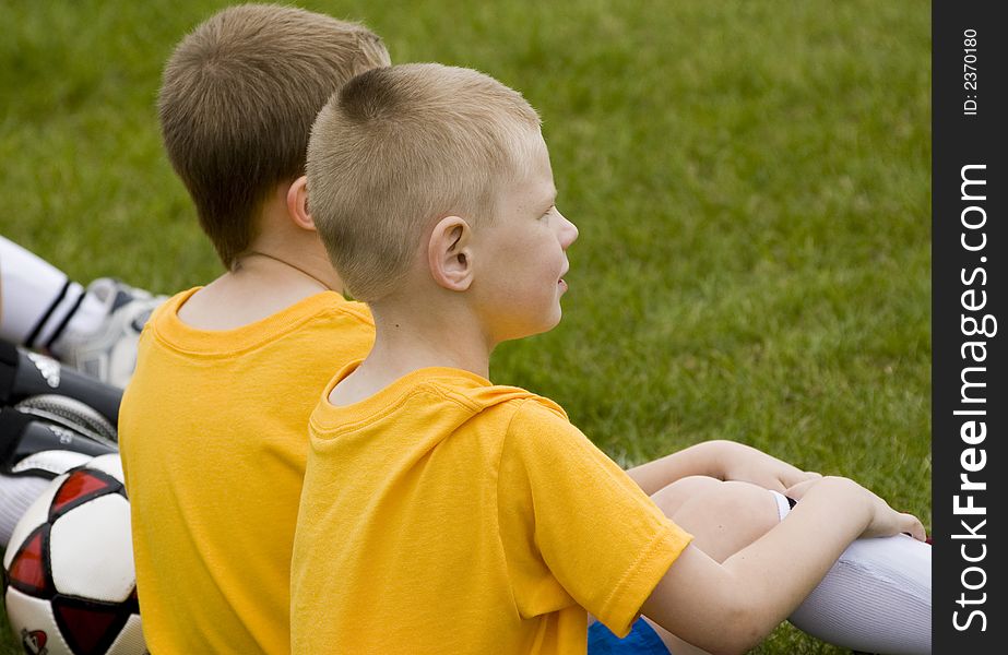 Here is a photo of two young boys waiting patiently on the sideline for their turn to play soccer. Here is a photo of two young boys waiting patiently on the sideline for their turn to play soccer.