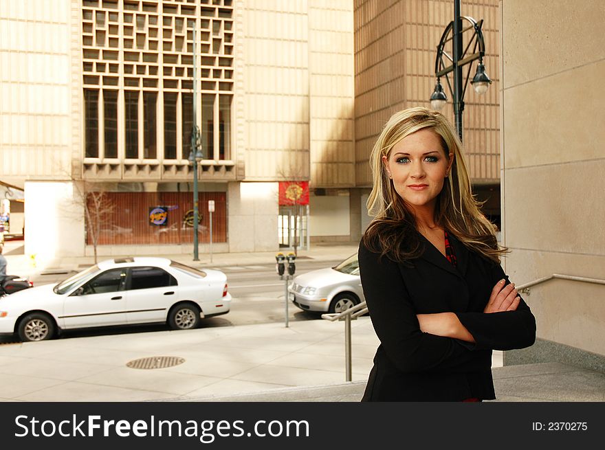 Business woman is outside of business buildings