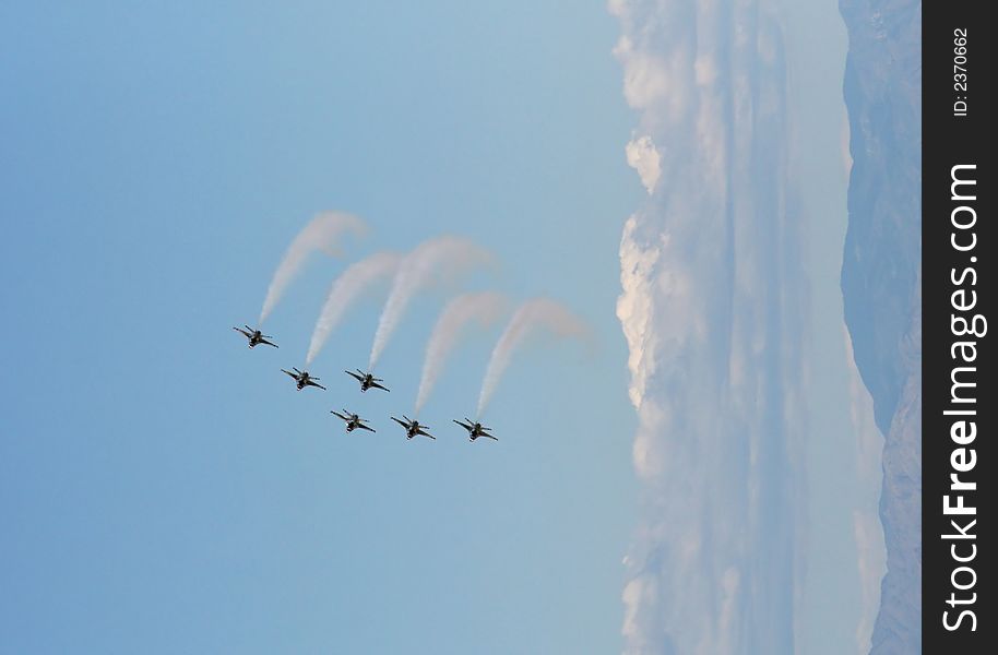 Six fighter jets flying in formation against a clear blue sky