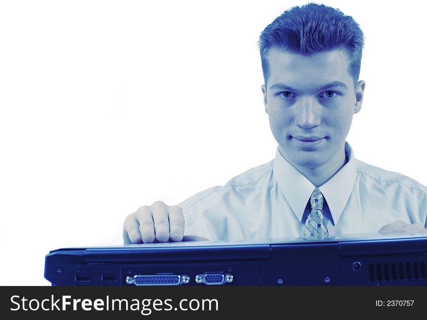 Portrait,  young businessman works on laptop and looks in an objective. Portrait,  young businessman works on laptop and looks in an objective