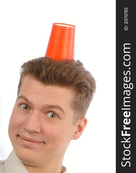 Portrait emotional young  student with  plastic glass of red color on  head. Portrait emotional young  student with  plastic glass of red color on  head