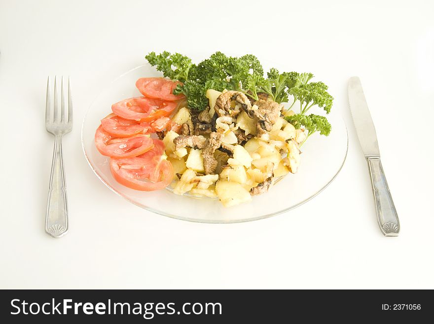 A close up of a plate  with vegetables and with Cutlery