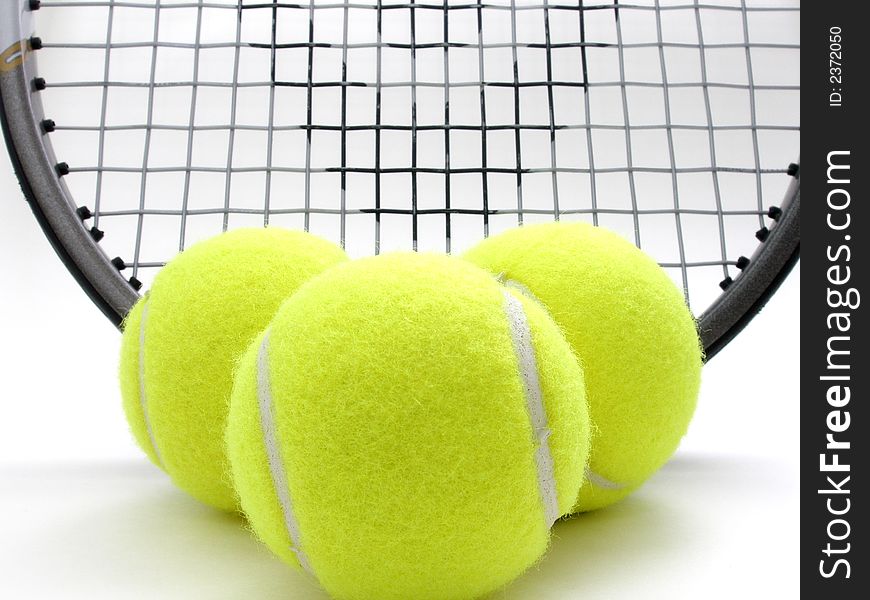 Three tennis balls and raquet. Three tennis balls and raquet