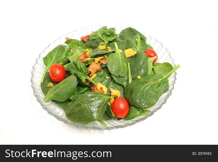 Isolated photo of a spinach salad on white background