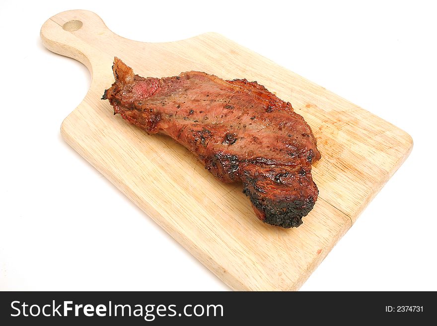 Isolated photo of a steak on cutting board on white