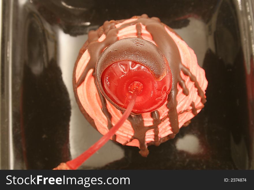 Isolated photo of a choclolate covered cherry bite upclose on white