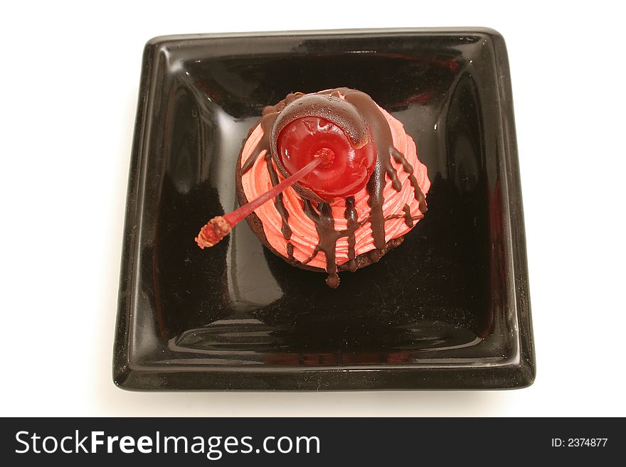 Isolated photo of a chocolate covered cherry brownie bite upclose on white