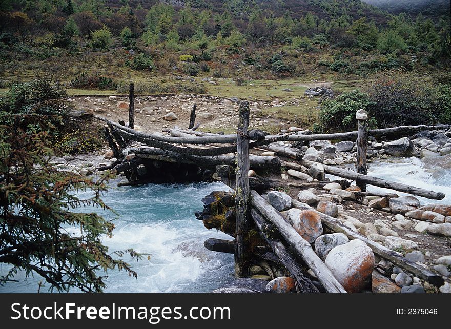 On brook wooden bridge in forest