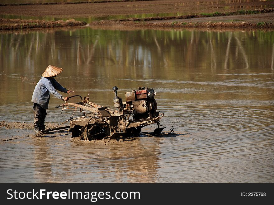 Plough machine and paddy field at the countryside