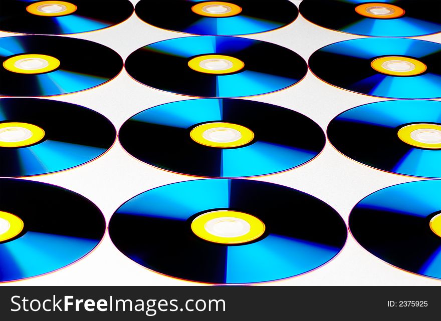 View of compact discs on white sheet