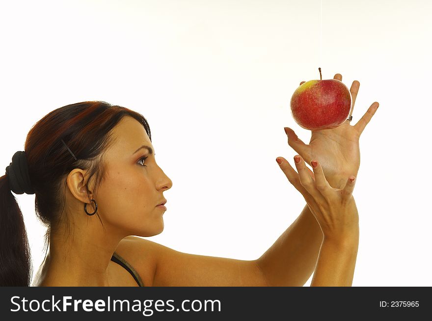 Healthy girl eating apples over a white background