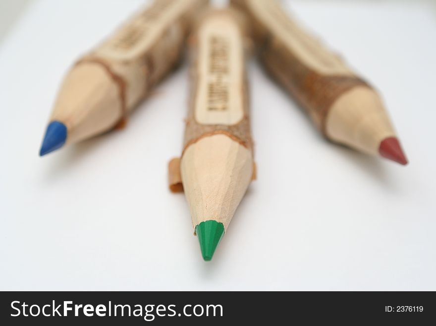Three pencils lay on a table