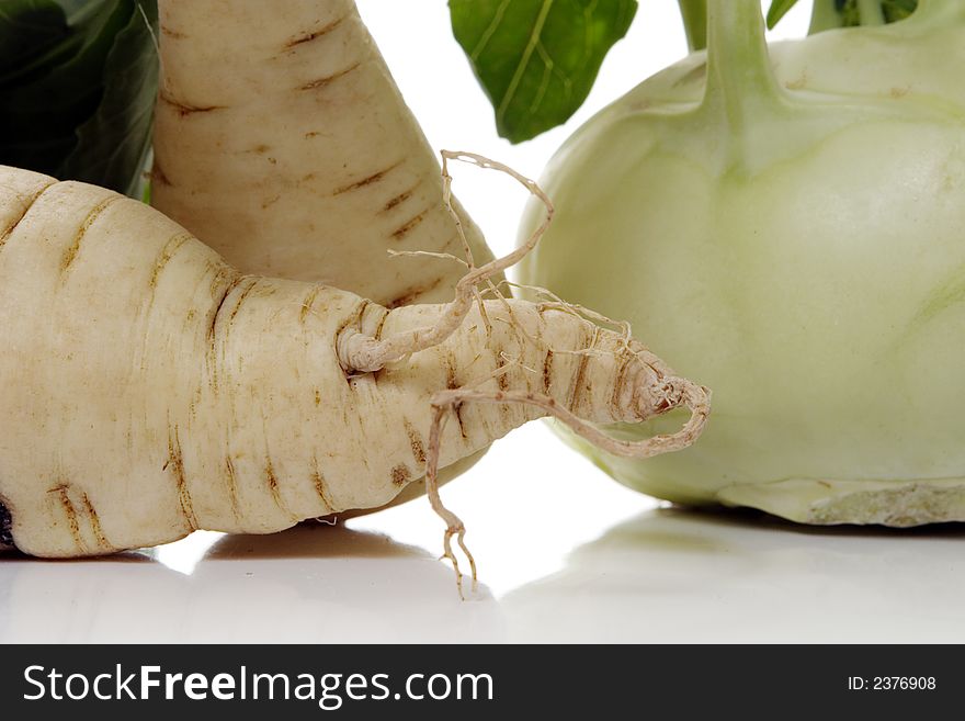 Root of parsley and kohlrabi over white background. Root of parsley and kohlrabi over white background