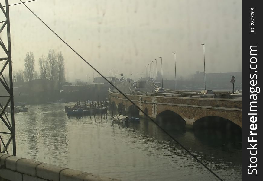 Arriving to Venice by train, view from the train's window to Ponte della Liberta, bridge connecting Venice to the mainland