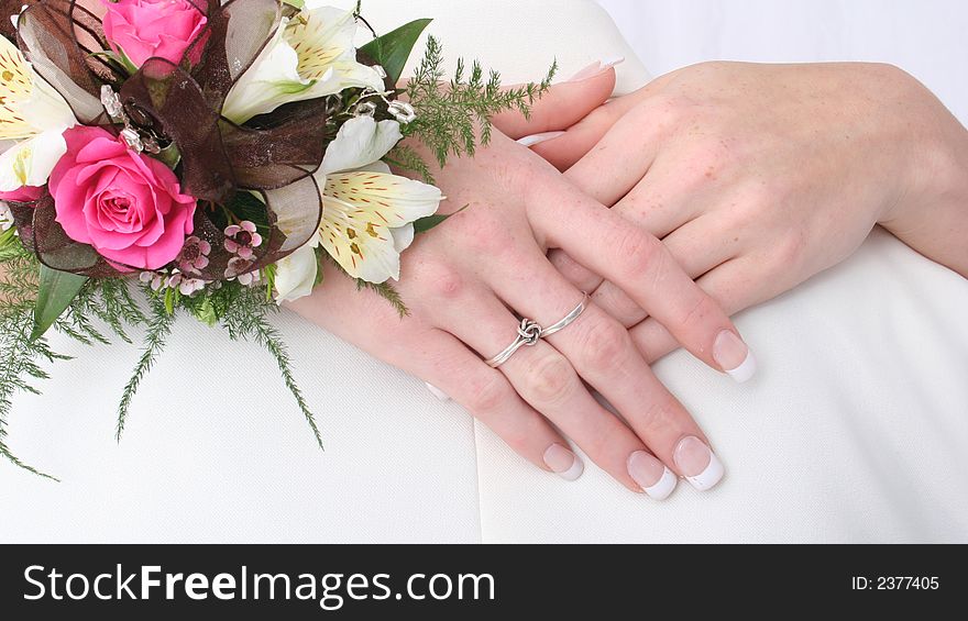 Female hands held together showing off rings and flowers