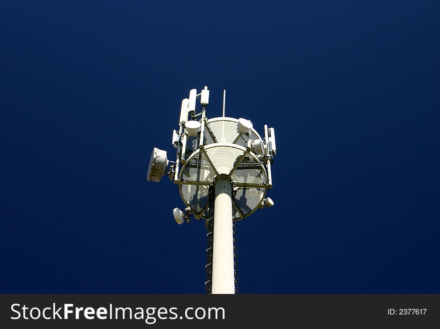 View at top of a aerial tower on a dark blue sky background. View at top of a aerial tower on a dark blue sky background