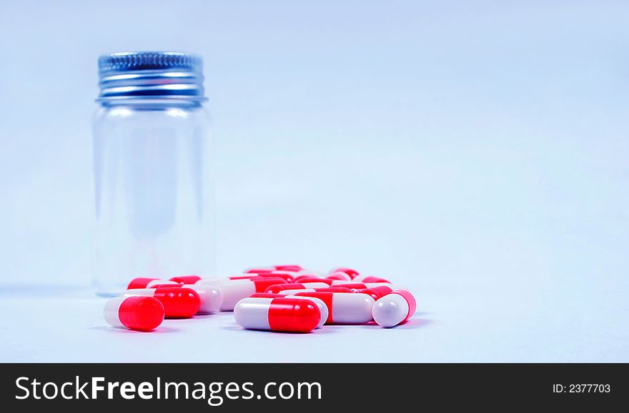 Pills next to an empty jar