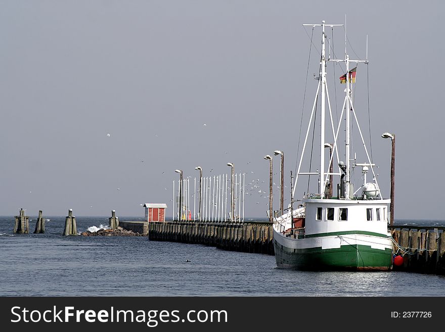 Fisherboat by a pier in harbour