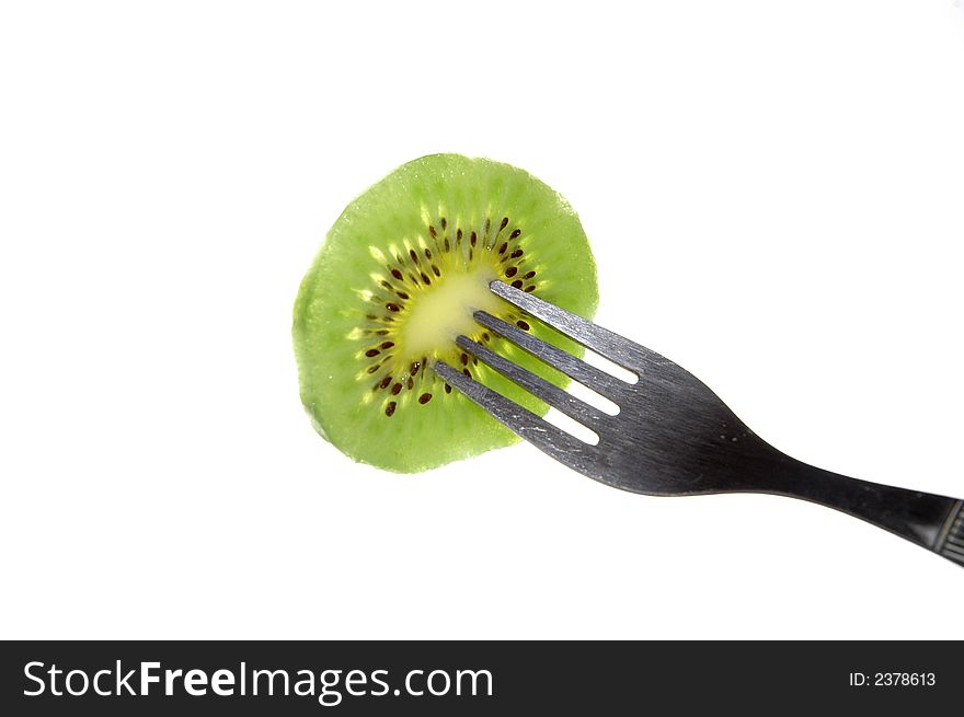 Kiwi and fork on white background. Kiwi and fork on white background