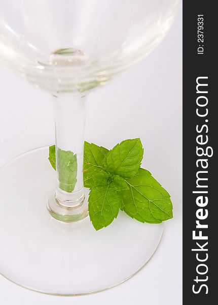 Mint leaves near glass ISOLATED on white