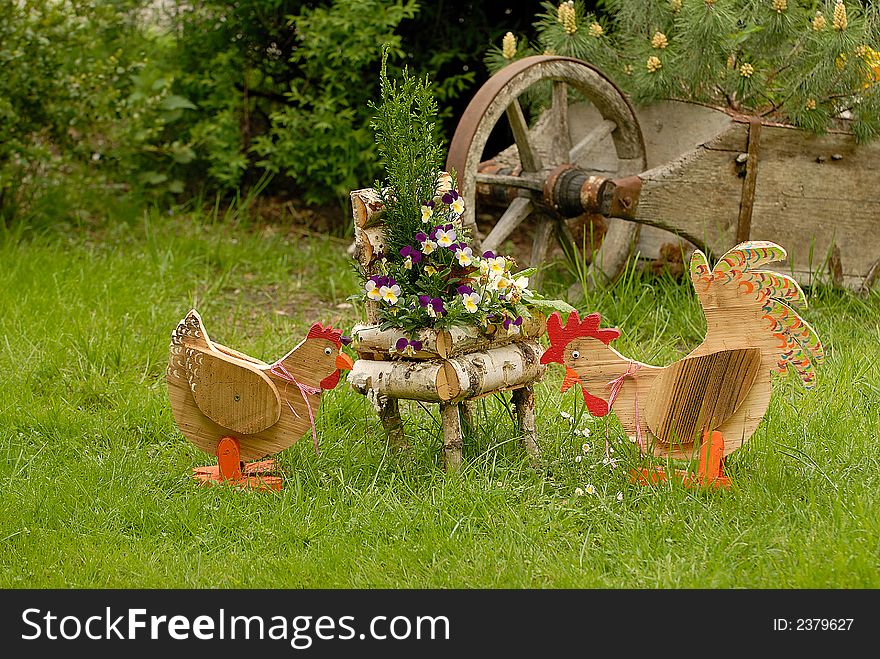 Rooster and hen models in the peasant garden. Rooster and hen models in the peasant garden