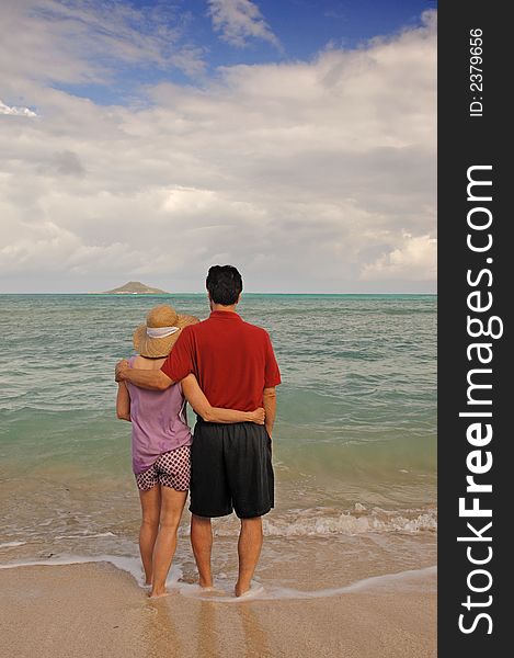 Mid-life aged romantic couple together on a tropical beach. Mid-life aged romantic couple together on a tropical beach