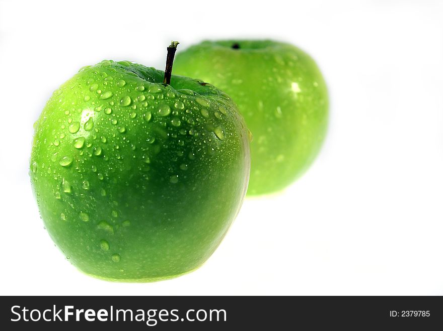 Two Clouse-up macro green apple on the white background. Two Clouse-up macro green apple on the white background.