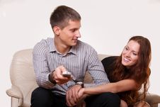 Young Couple Arguing Over The TV Remote Stock Images