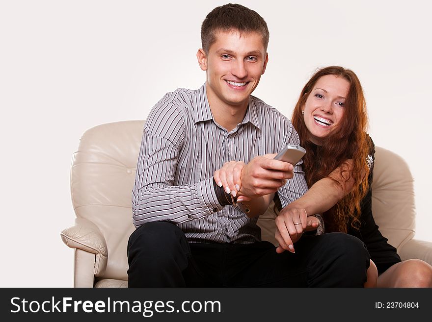 Family sitting in front of TV on the couch