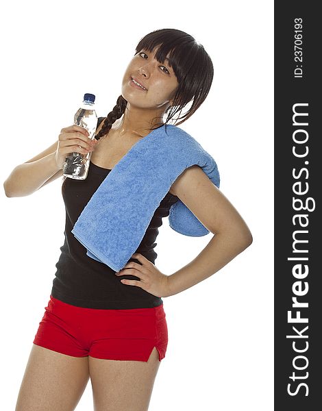 Young Asian woman with a bottle of water and towel after being working out. Isolated on white