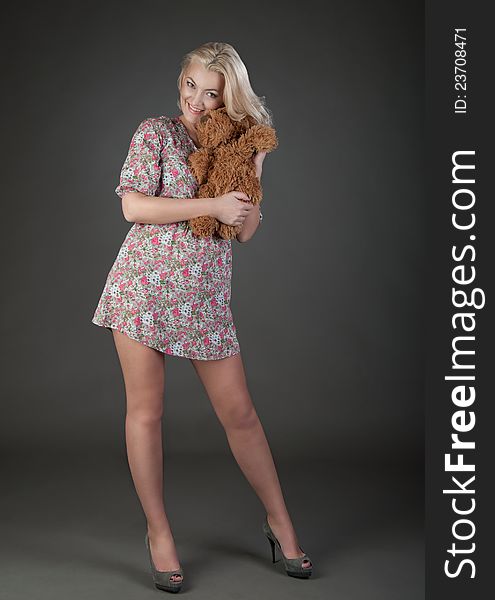 Beautiful blonde woman holding teddy bear. Beautiful blonde woman holding teddy bear