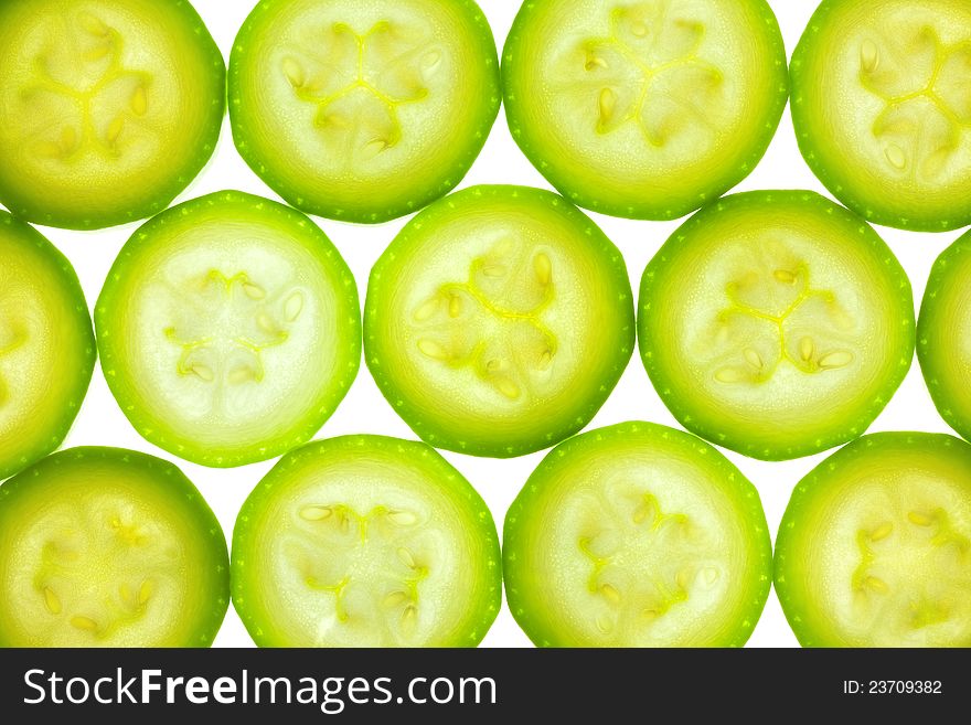 Slices of zucchini or courgette isolated on white