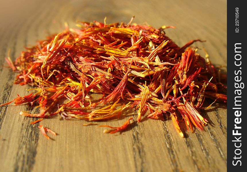 Pile of saffron on wooden background ( close up)